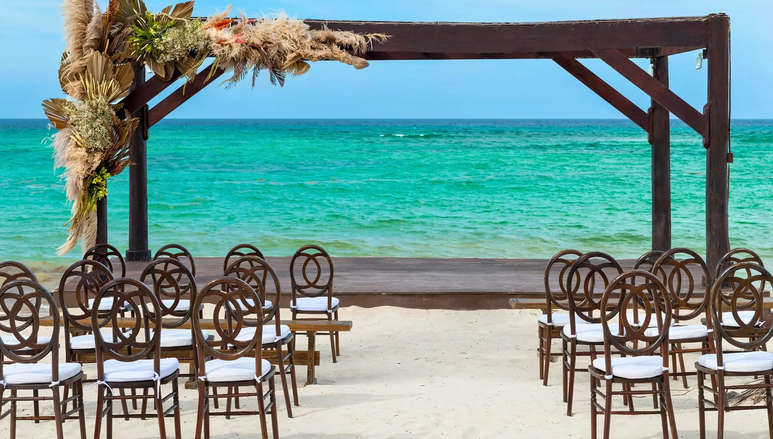 Beachfront wedding ceremony with a dark wood gazebo at Royalton Bavaro, Punta Cana