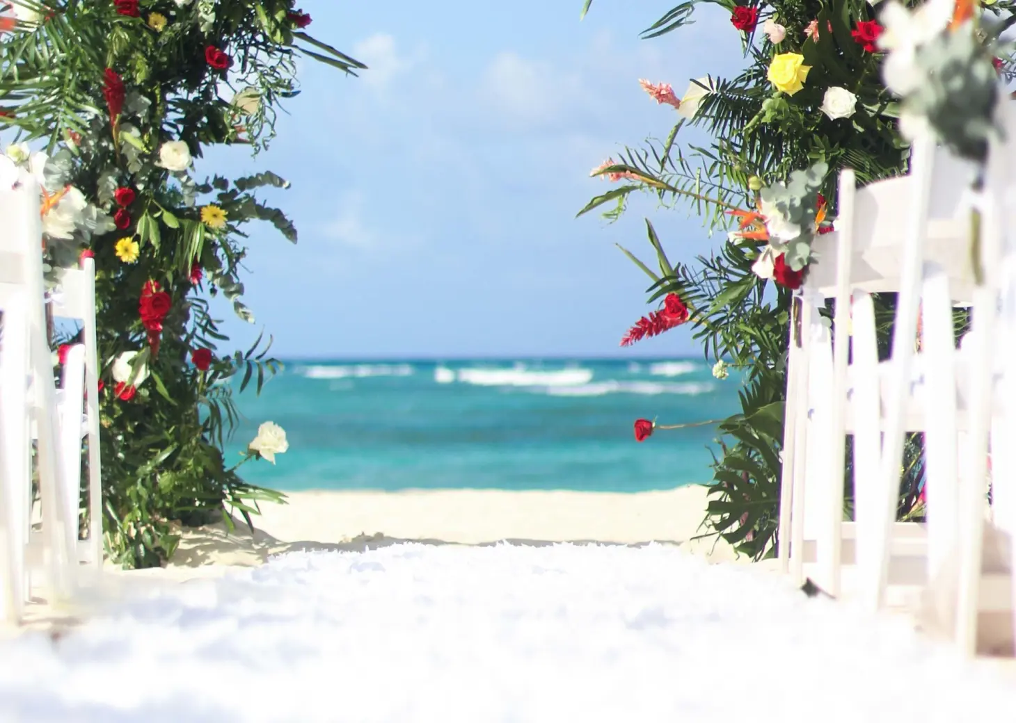 Floral wedding ceremony arch on the beach at Royalton Bavaro, Punta Cana