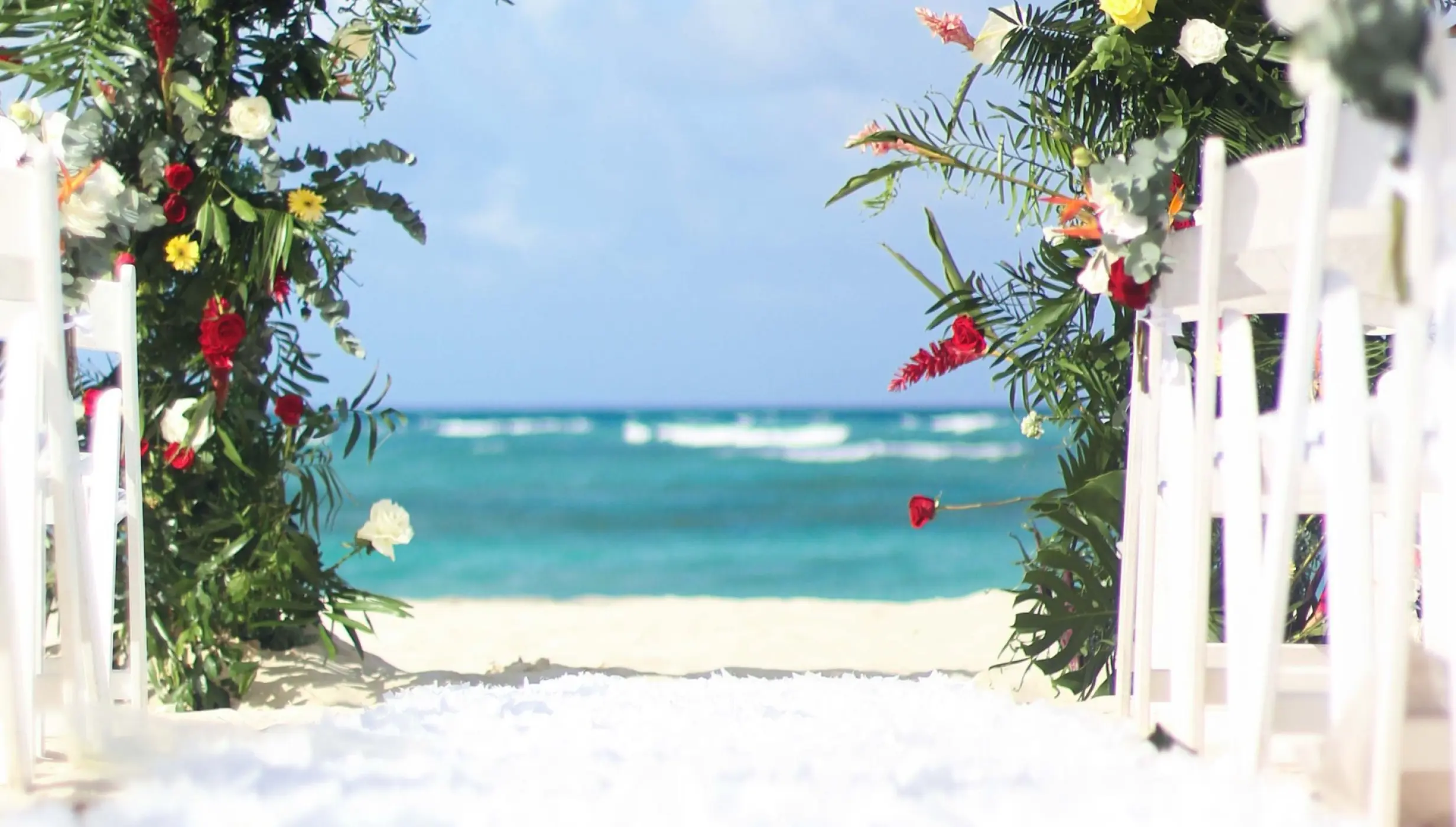 Floral wedding ceremony arch on the beach at Royalton Bavaro, Punta Cana