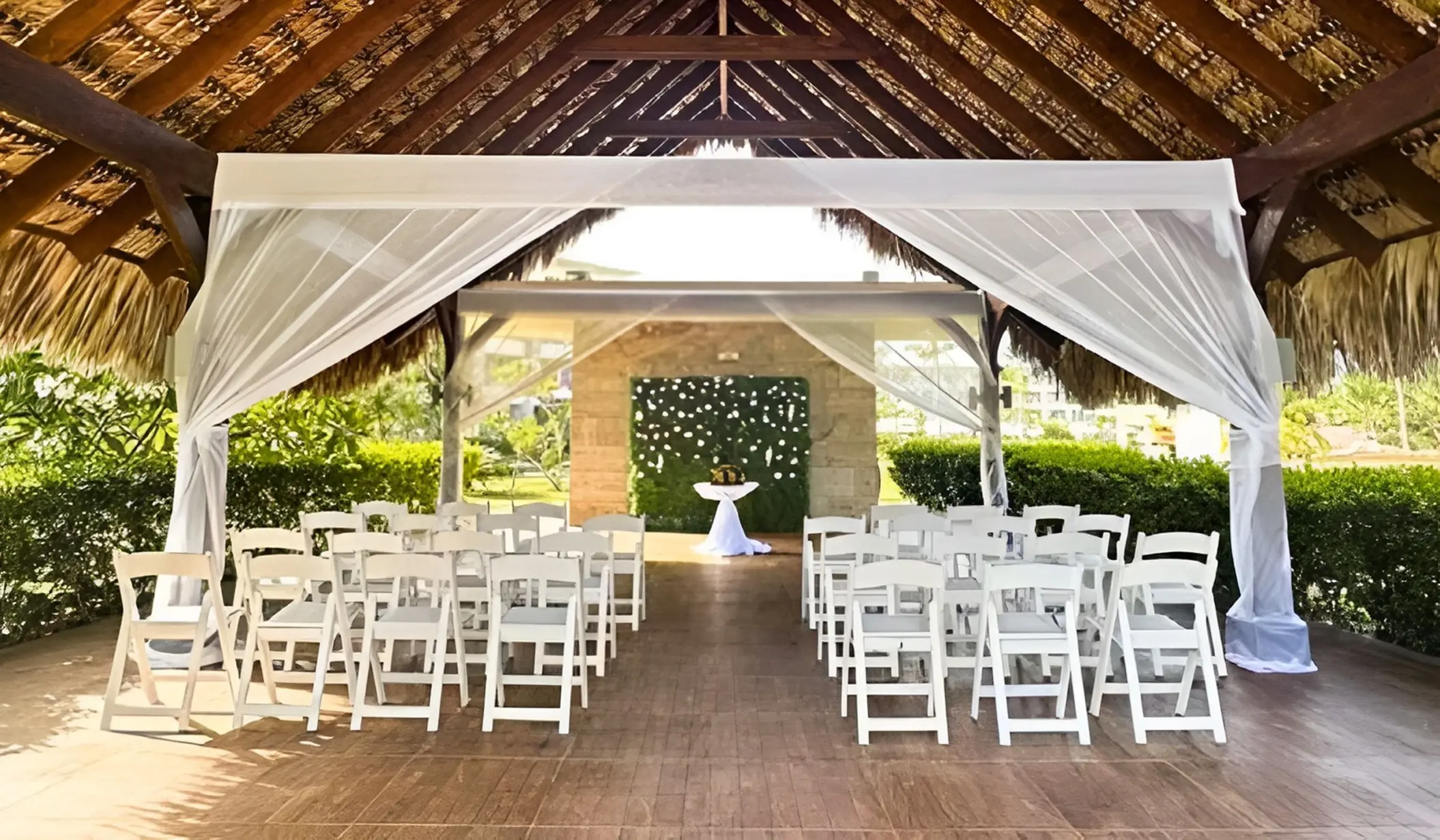 Garden terrace wedding ceremony under a thatched gazebo at Royalton Bavaro, Punta Cana