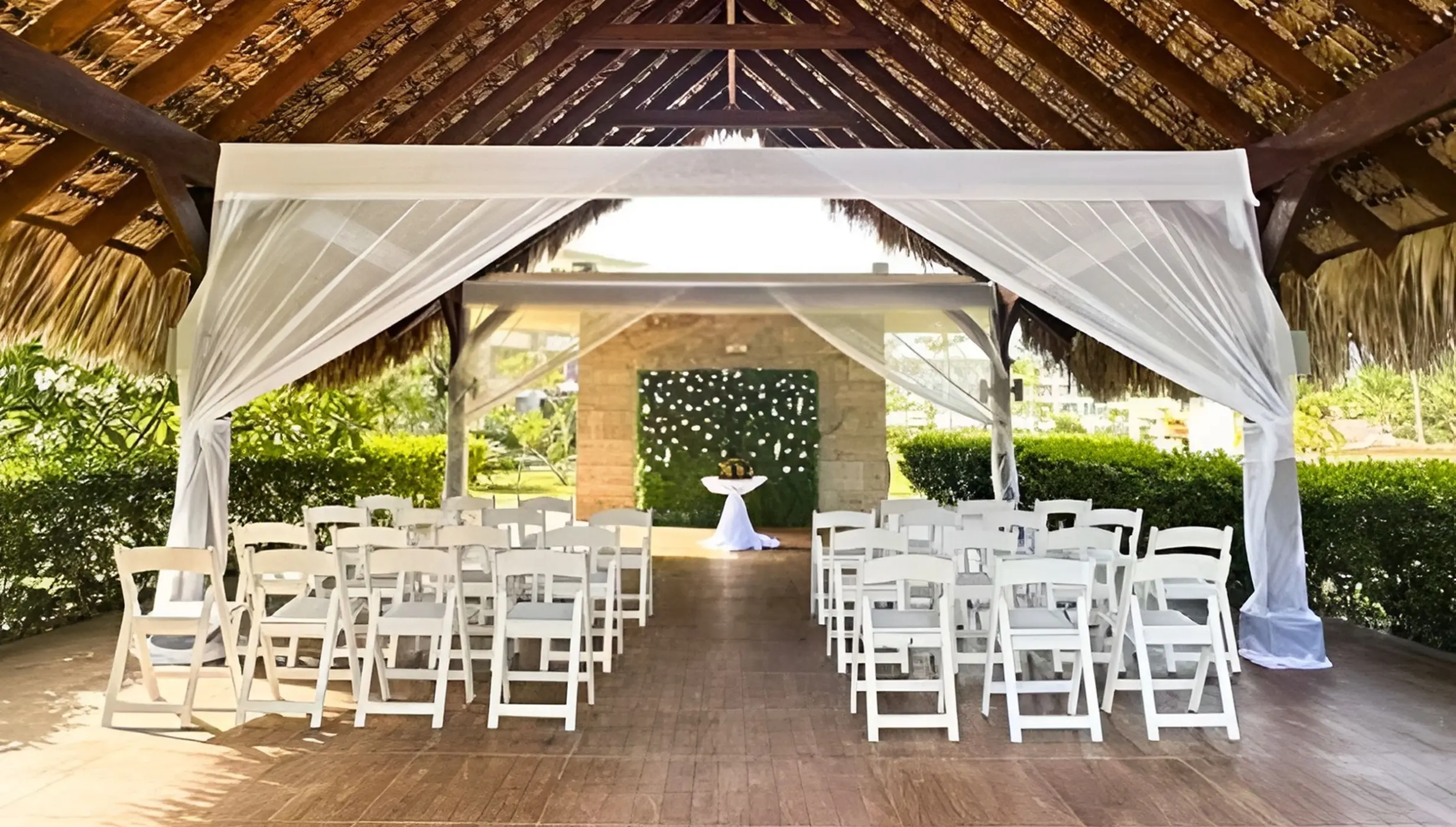 Garden terrace wedding ceremony under a thatched gazebo at Royalton Bavaro, Punta Cana