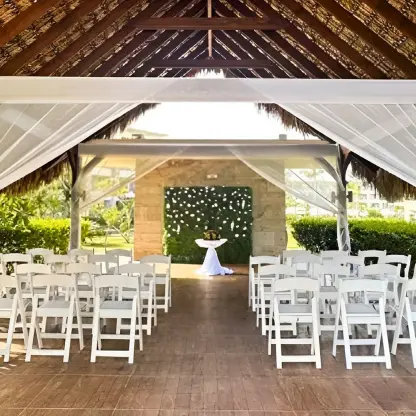 Garden terrace wedding ceremony under a thatched gazebo at Royalton Bavaro, Punta Cana