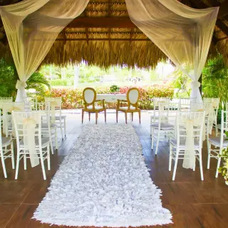 Garden gazebo wedding ceremony setup with a petal aisle at Royalton Bavaro, Punta Cana