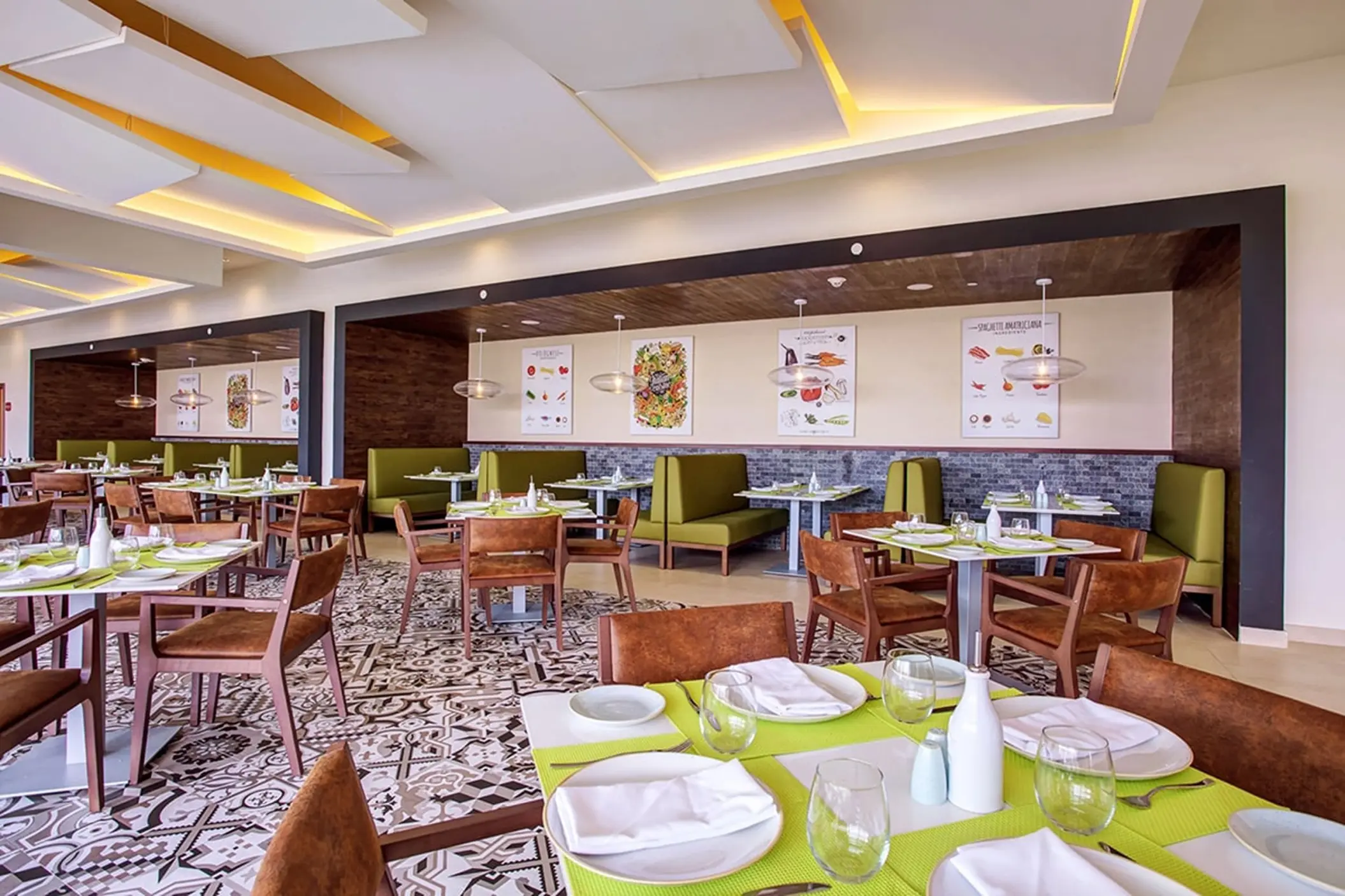 Grazie Italian Trattoria with set tables and green booth seating at Royalton Bavaro, Punta Cana