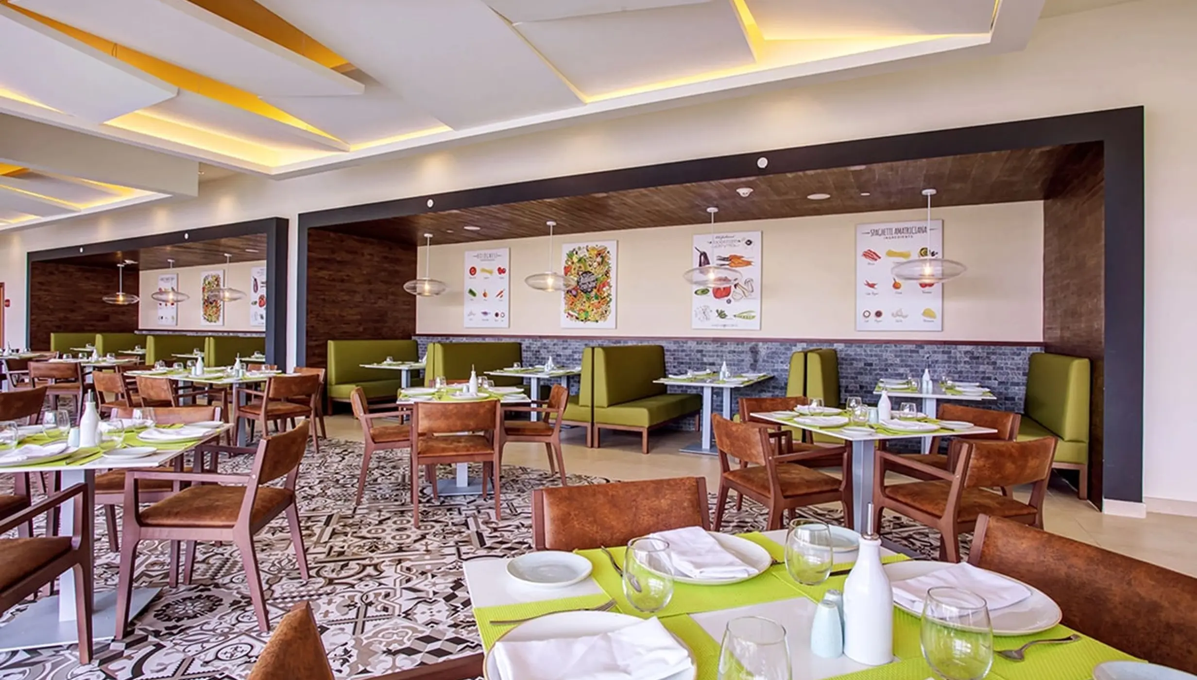 Grazie Italian Trattoria with set tables and green booth seating at Royalton Bavaro, Punta Cana