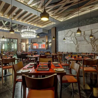 Hunter Steakhouse dining room with modern lighting and cow wall art at Royalton Bavaro, Punta Cana