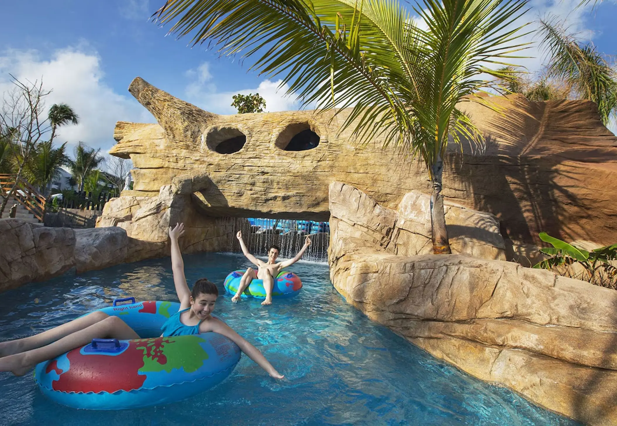 Children on colorful tubes floating down the lazy river at Royalton Bavaro, Punta Cana