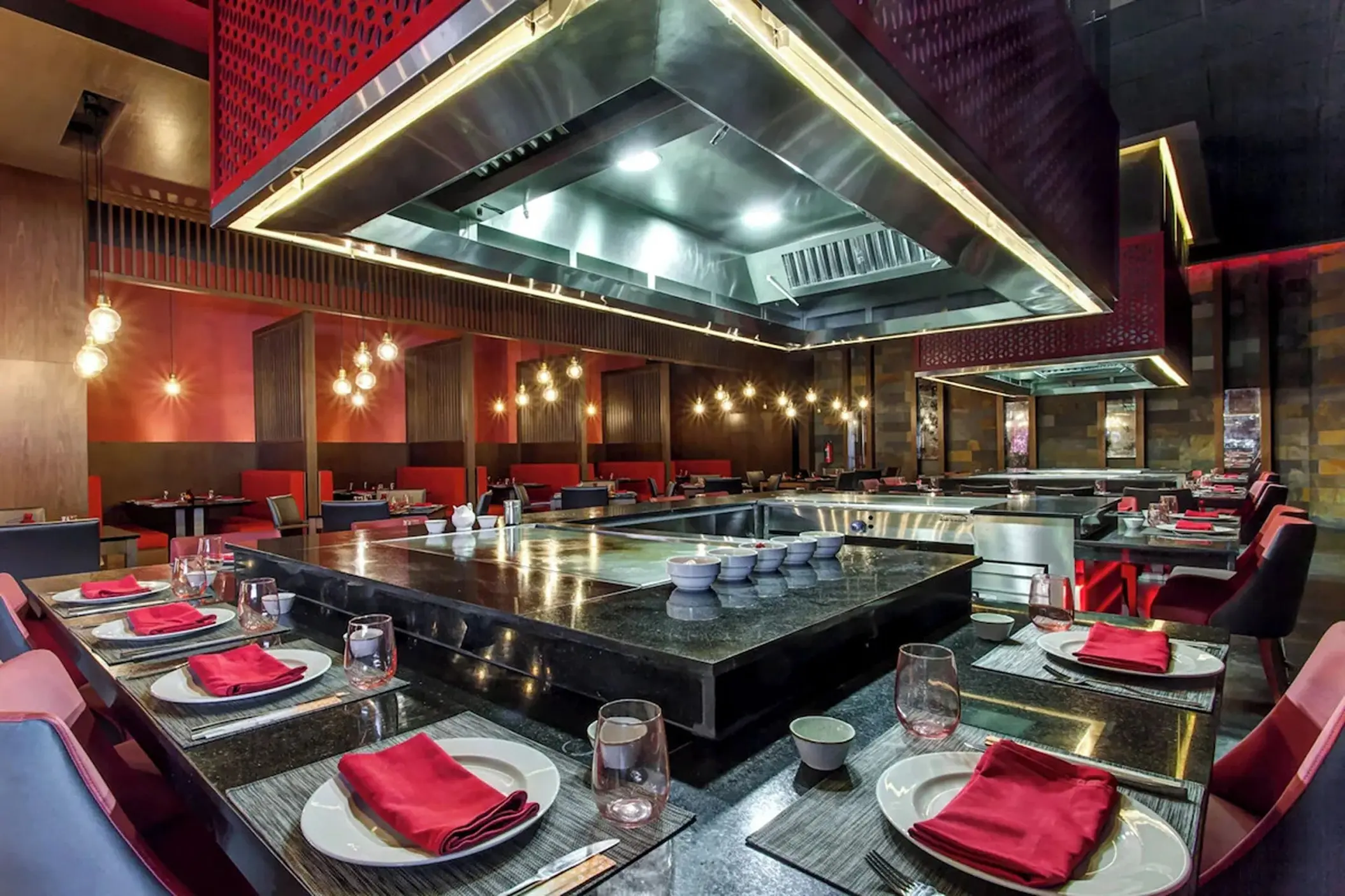 Teppanyaki dining room with red napkins and modern lighting at Royalton Bavaro, Punta Cana