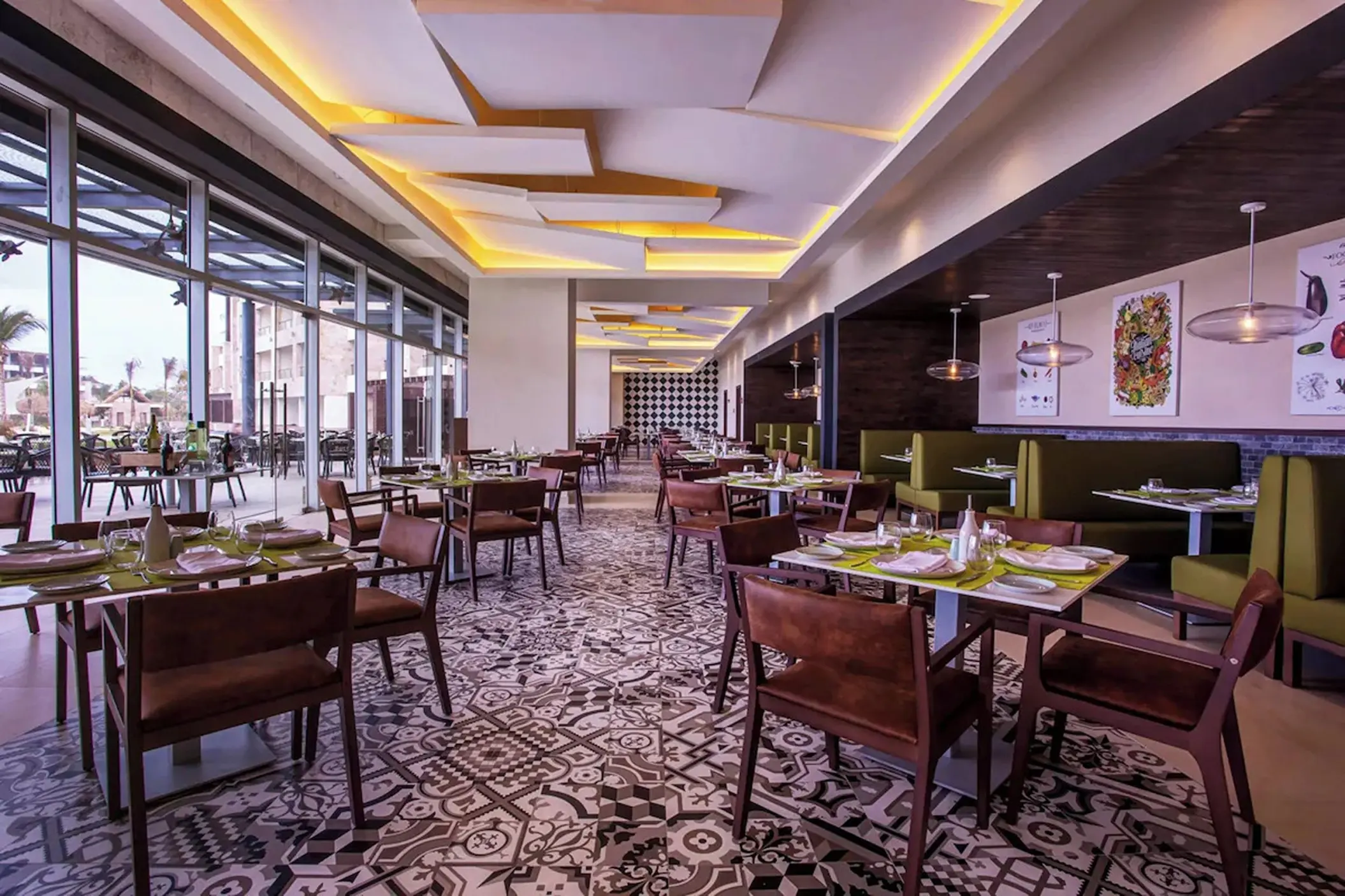 Modern restaurant interior with geometric floor tiles and floor-to-ceiling windows at Royalton Bavaro, Punta Cana