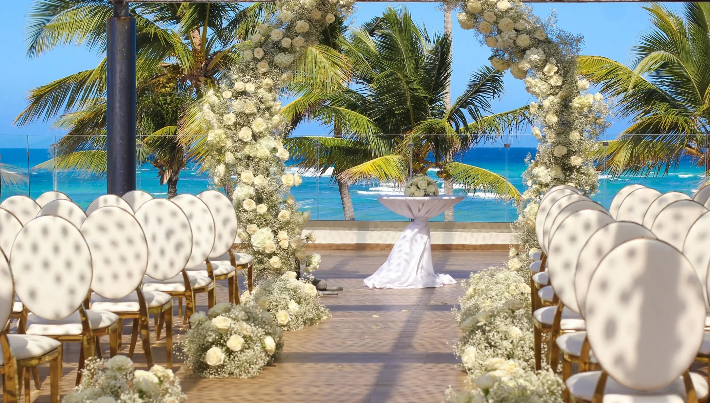 Sky Terrace wedding ceremony setup with a white flower arch at Royalton Bavaro, Punta Cana