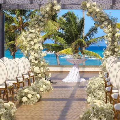 Sky Terrace wedding ceremony setup with a white flower arch at Royalton Bavaro, Punta Cana