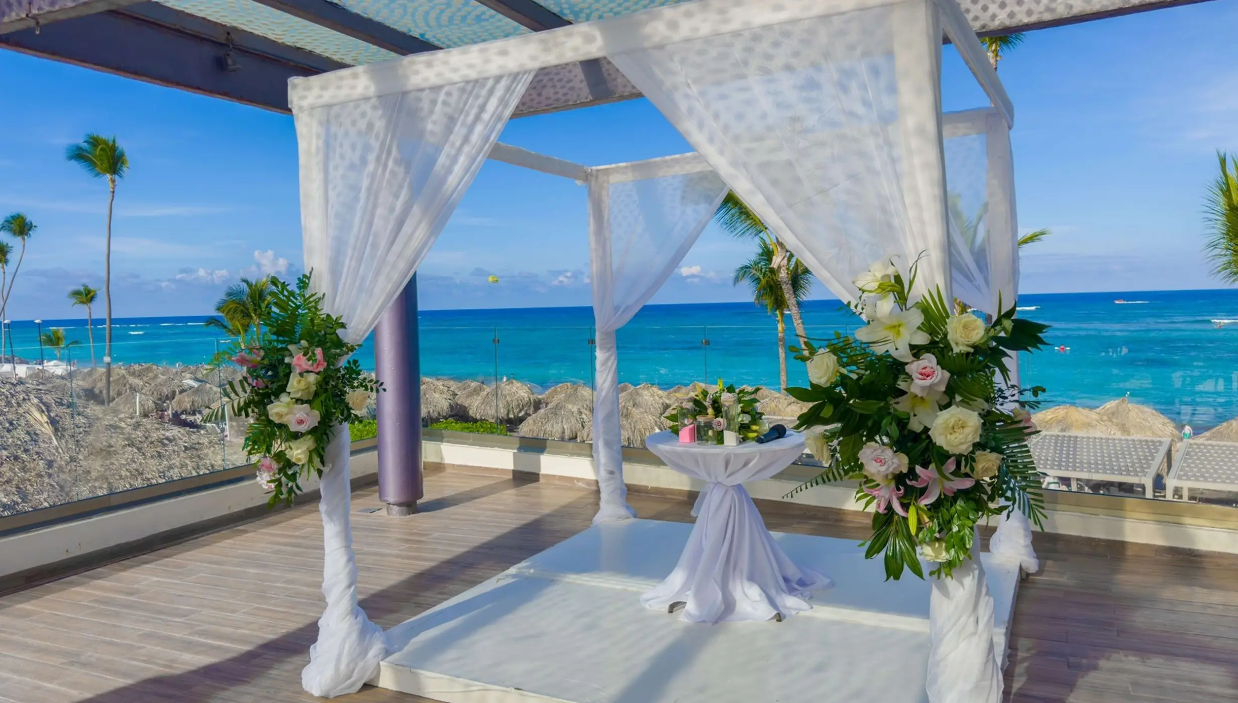 Sky terrace wedding ceremony setup with white floral arch at Royalton Bavaro, Punta Cana