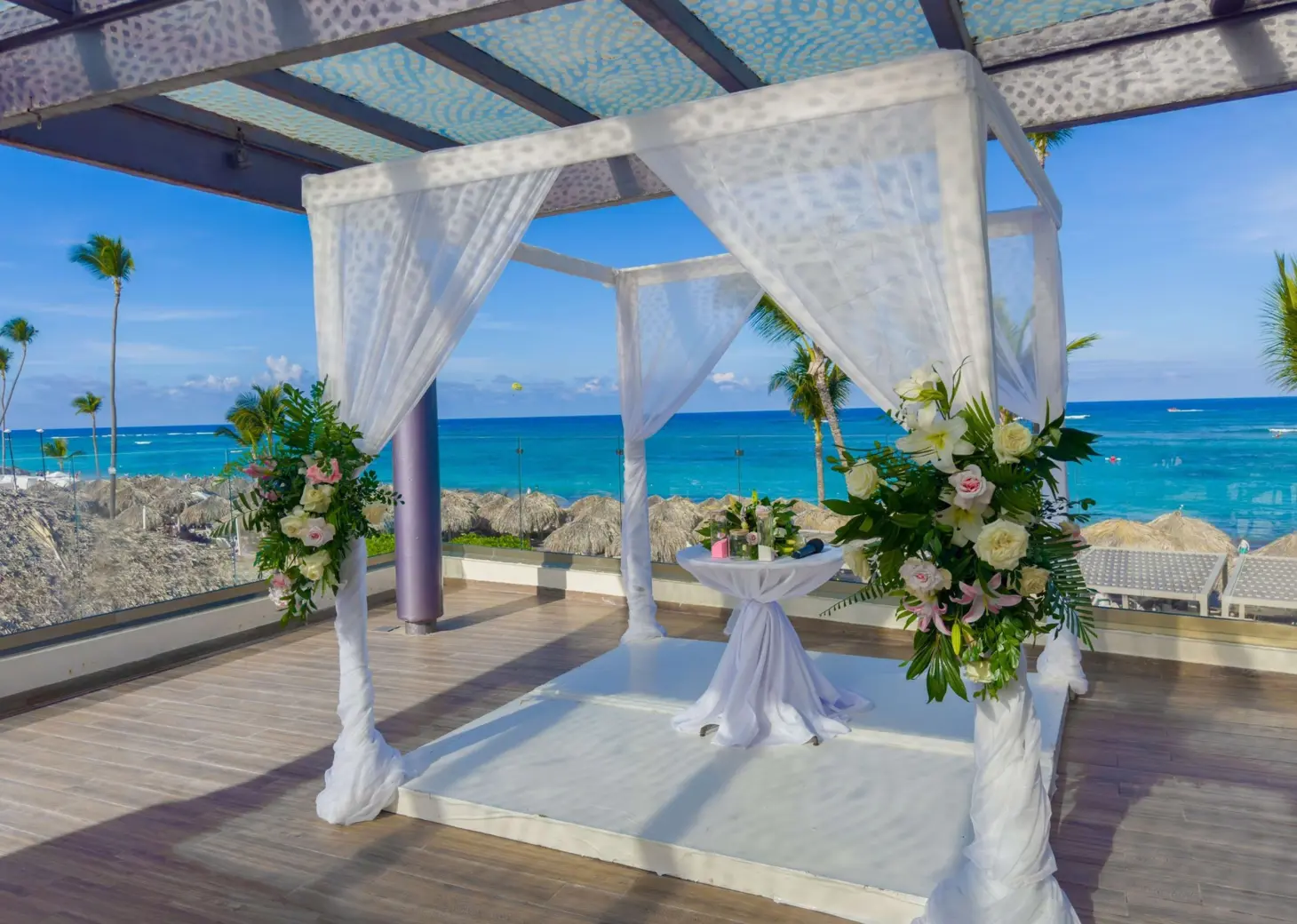 Sky terrace wedding ceremony setup with white floral arch at Royalton Bavaro, Punta Cana
