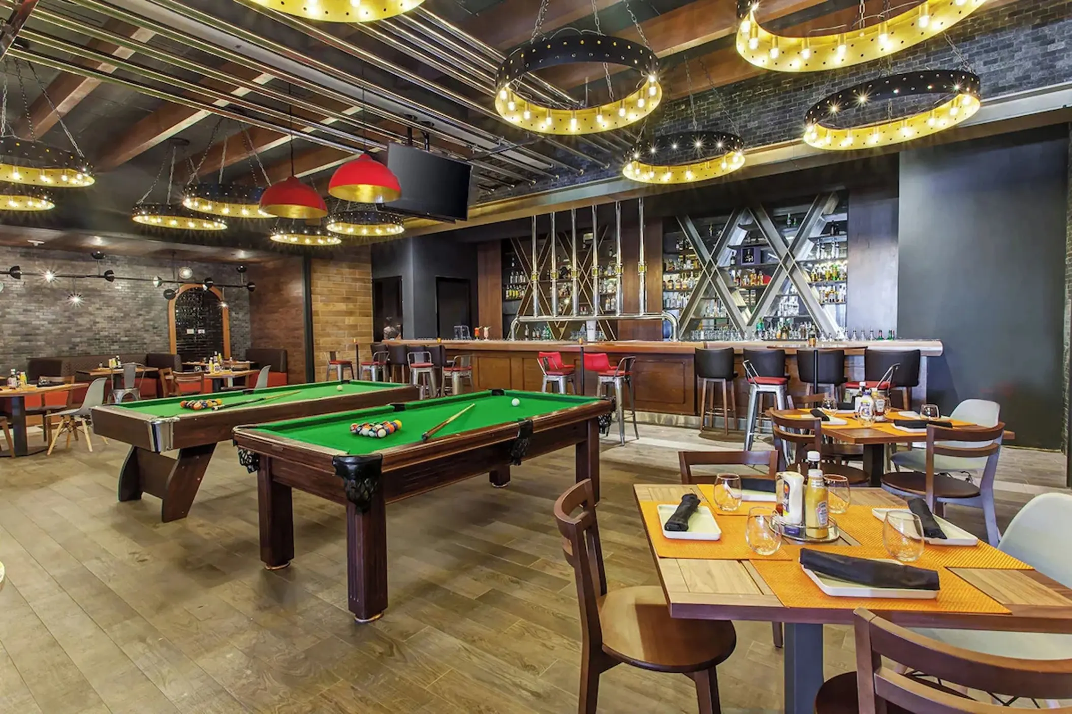 Sports bar with pool tables and modern lighting at Royalton Bavaro, Punta Cana