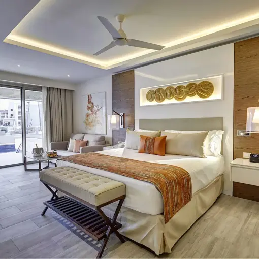 Swim-out suite with modern decor and king bed at Royalton Bavaro, Punta Cana
