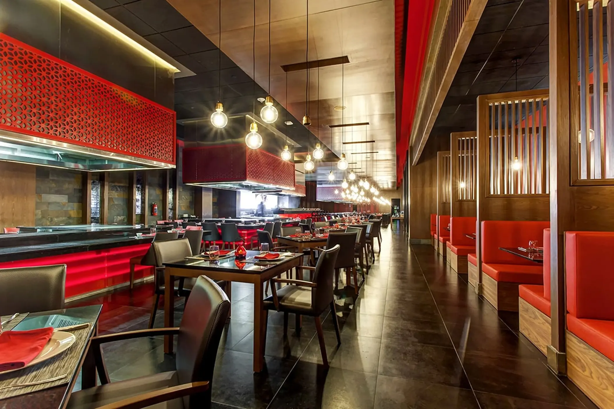 Zen Teppanyaki restaurant with red booth seating and modern lighting at Royalton Bavaro, Punta Cana