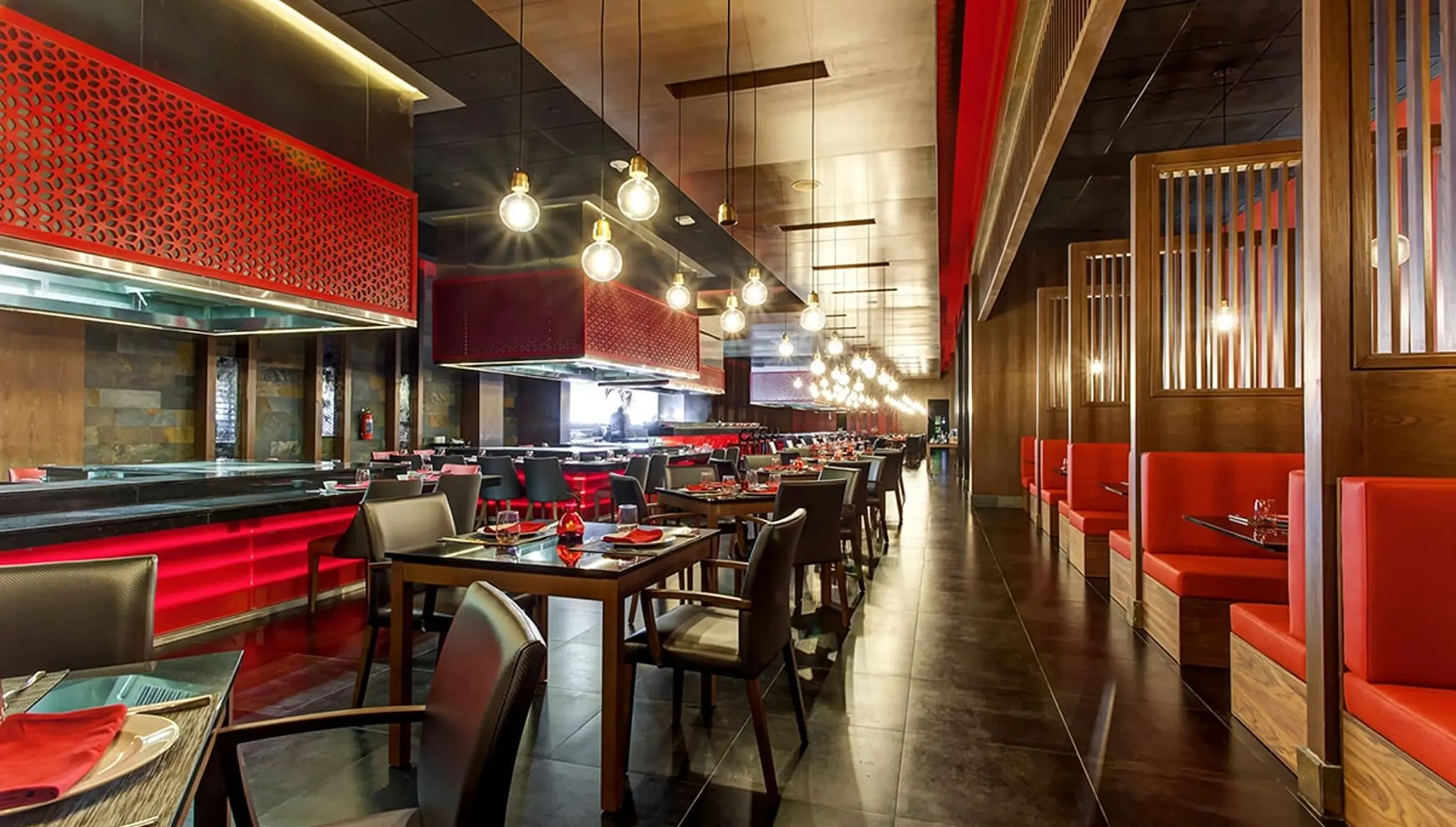 Zen Teppanyaki restaurant with red booth seating and modern lighting at Royalton Bavaro, Punta Cana