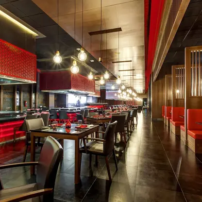 Zen Teppanyaki restaurant with red booth seating and modern lighting at Royalton Bavaro, Punta Cana