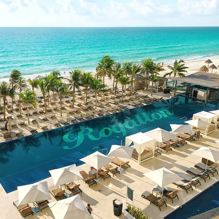 Beachfront swimming pool and lounge area at Royalton CHIC Cancun