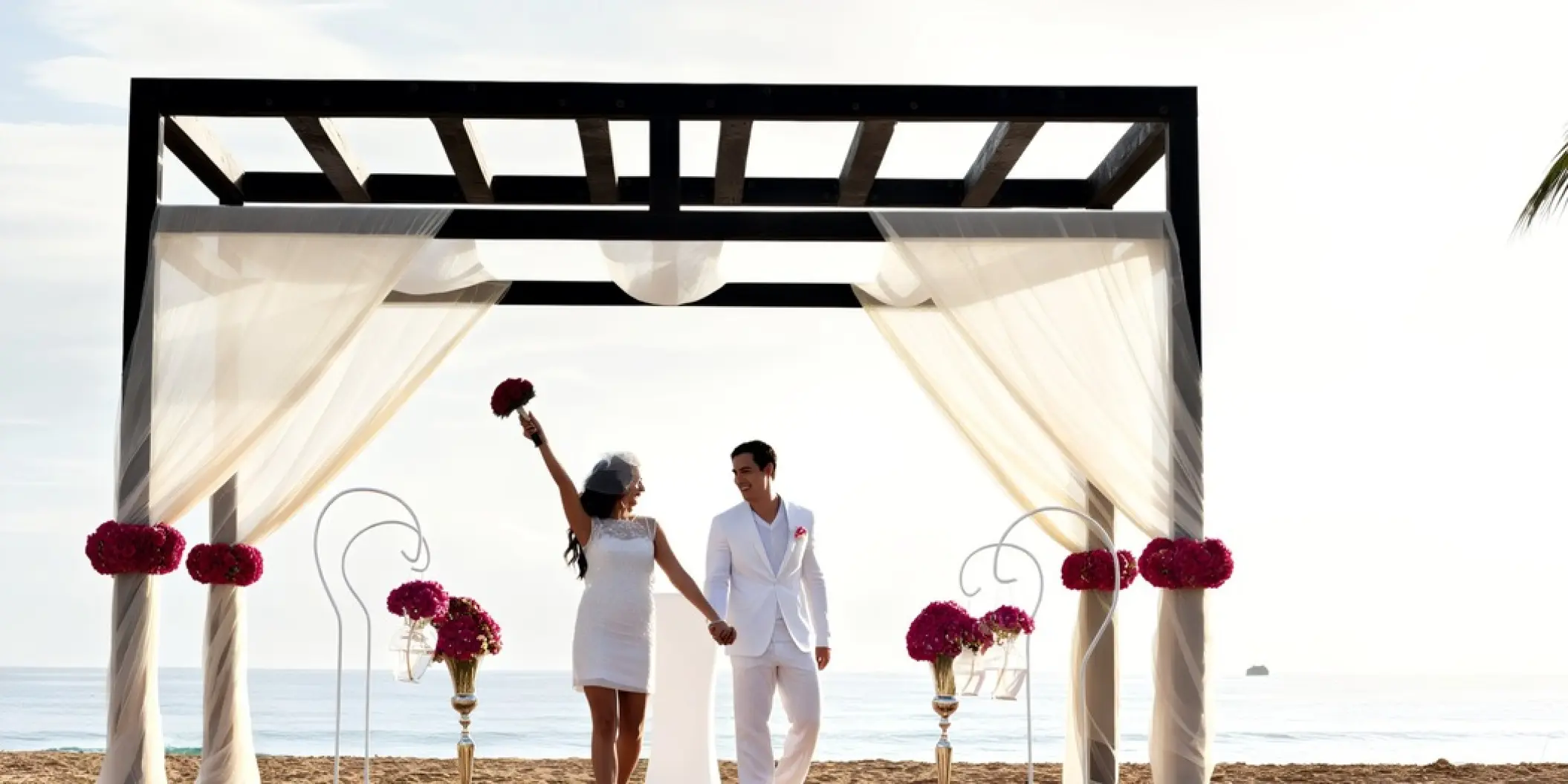 Bride and groom under a beach gazebo during a wedding at Royalton CHIC Punta Cana