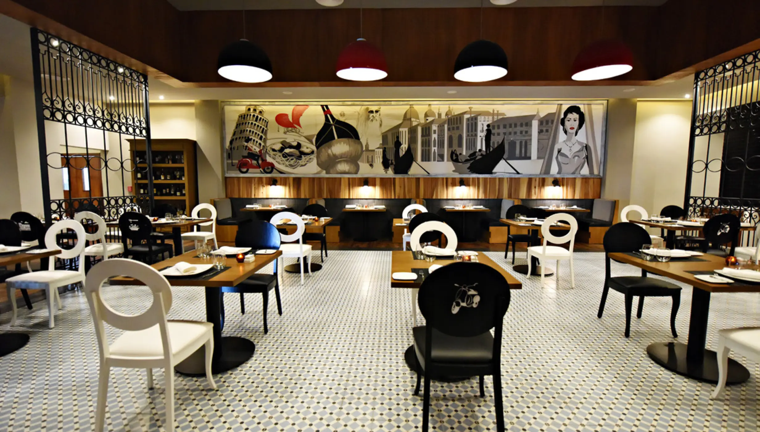 Vespa restaurant interior with patterned tile floors and Italian murals at Royalton CHIC Punta Cana