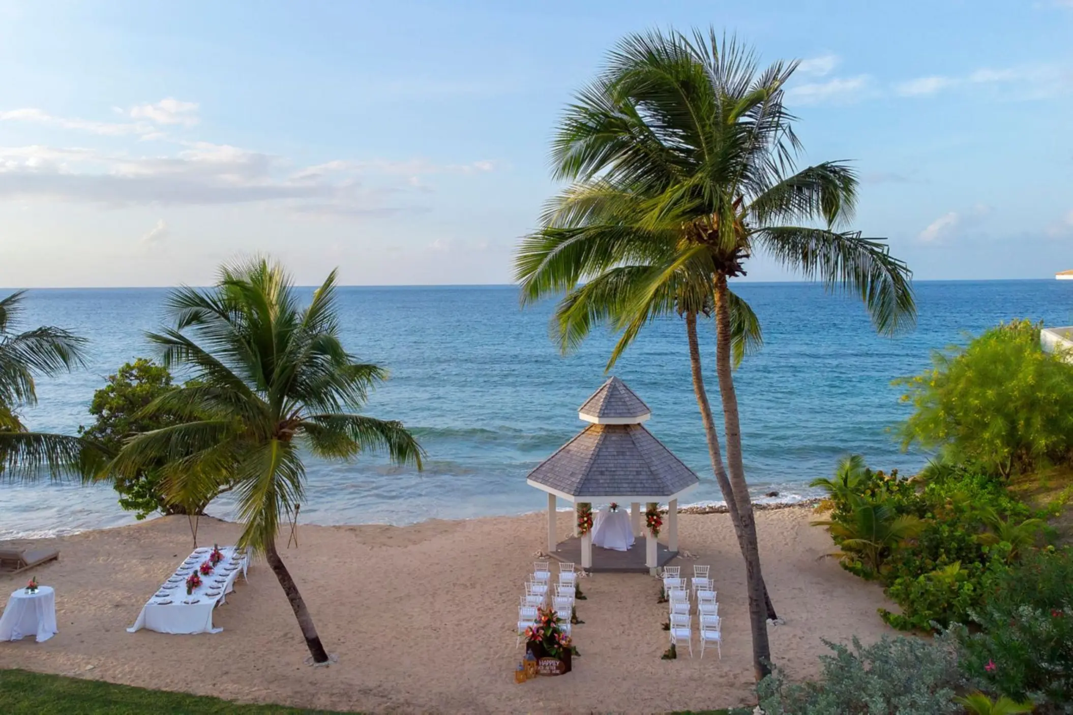 Beachfront wedding ceremony and dinner setup at Royalton Grenada, St. George’s