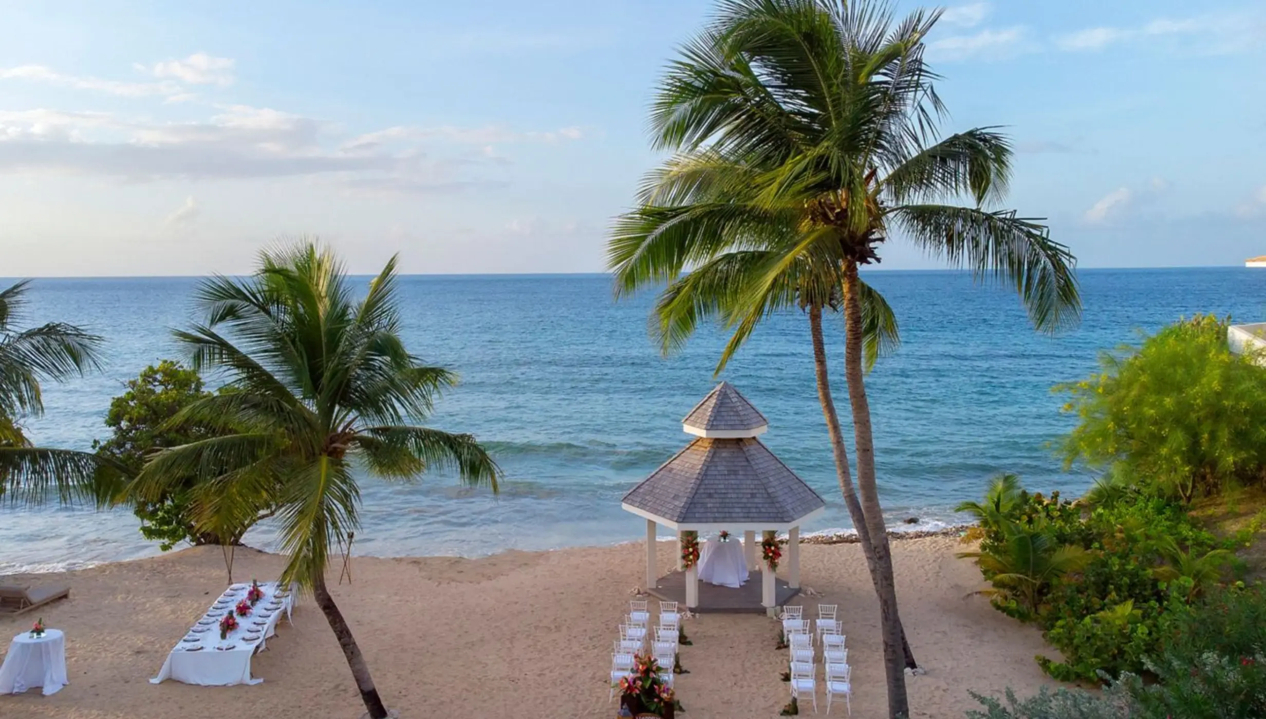 Beachfront wedding ceremony and dinner setup at Royalton Grenada, St. George’s