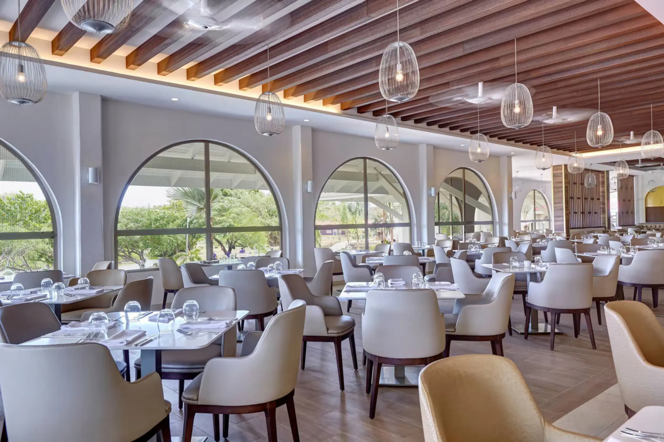 Gourmet Marche restaurant with arched windows and modern seating at Royalton Grenada, St. George’s