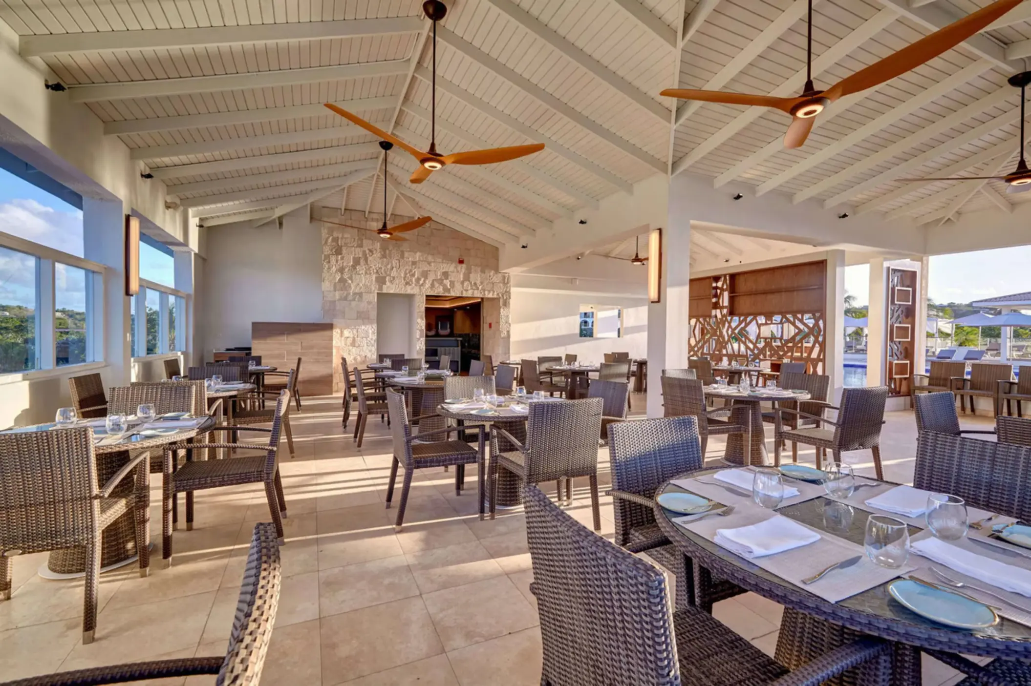 Grazie Italian Restaurant dining room with wicker chairs and vaulted ceilings at Royalton Grenada, St. George’s