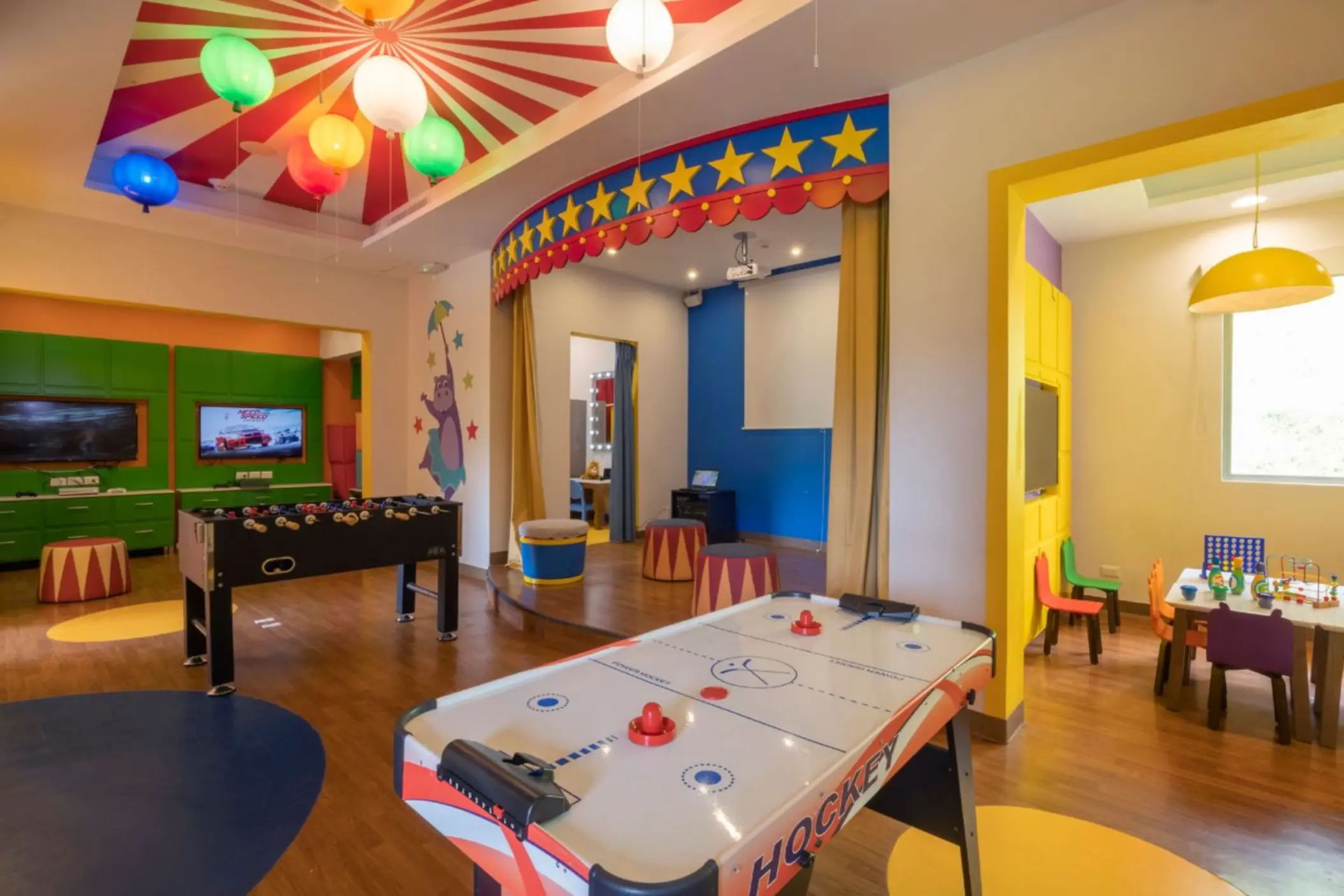 Colorful kids play area with air hockey, foosball, and a small stage at Royalton Grenada, St. George’s