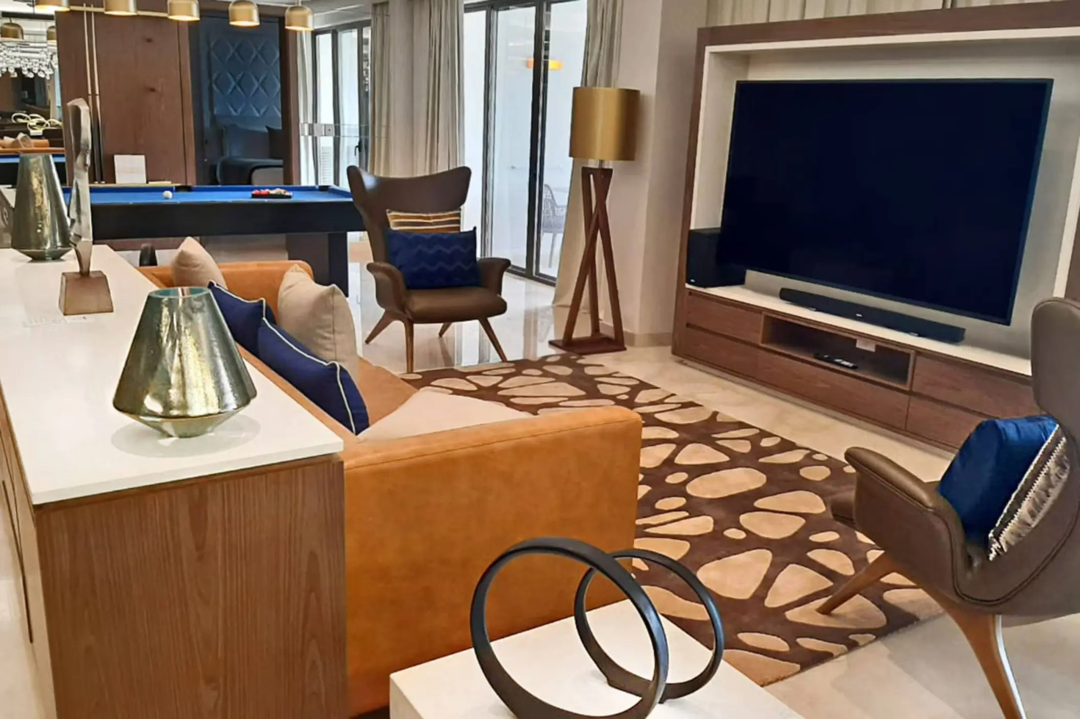 Chairman’s Suite living room with large TV and pool table at Royalton Grenada, St. George’s