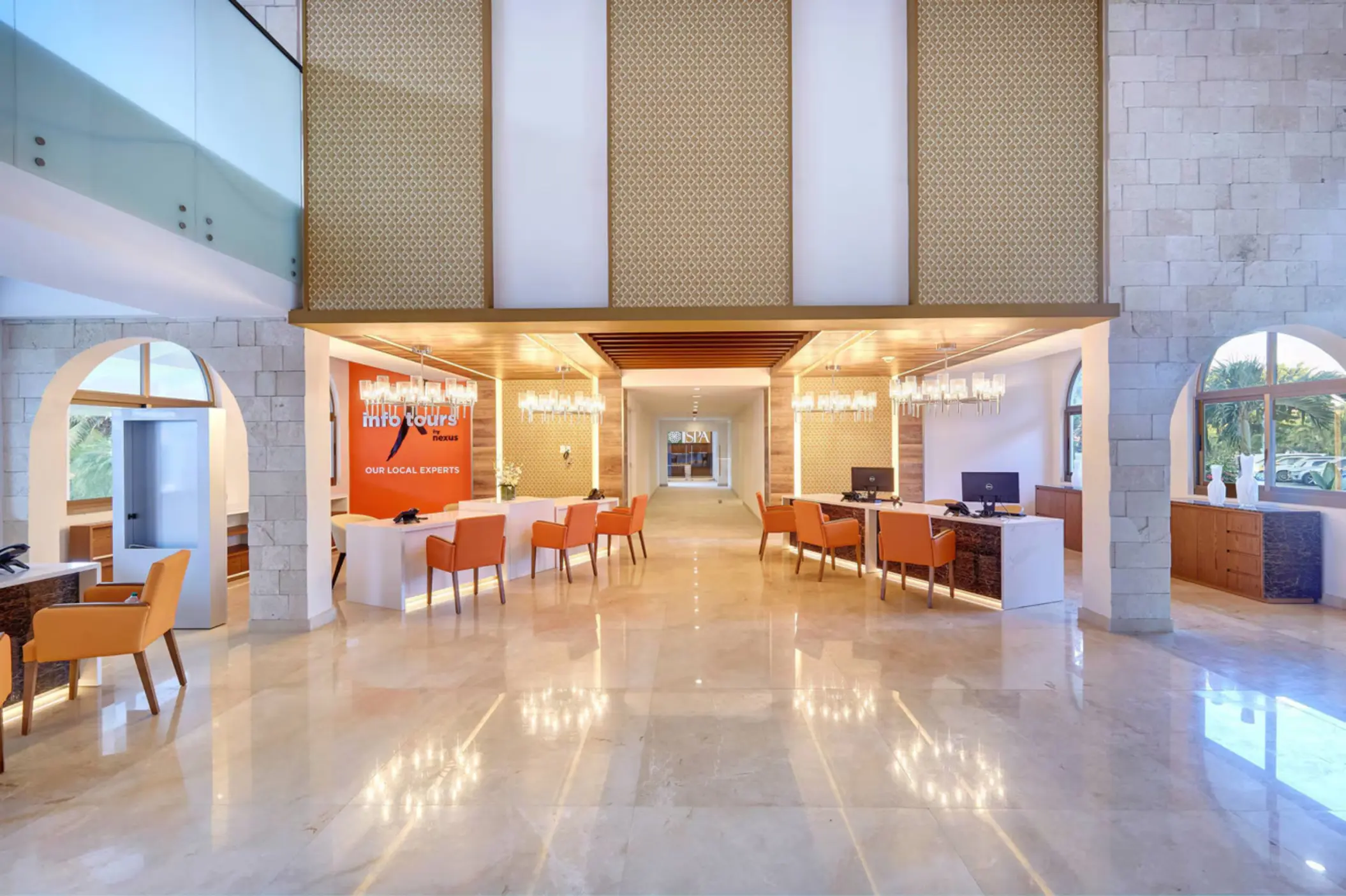 Modern lobby with white check-in desks and orange chairs at Royalton Grenada, St. George’s