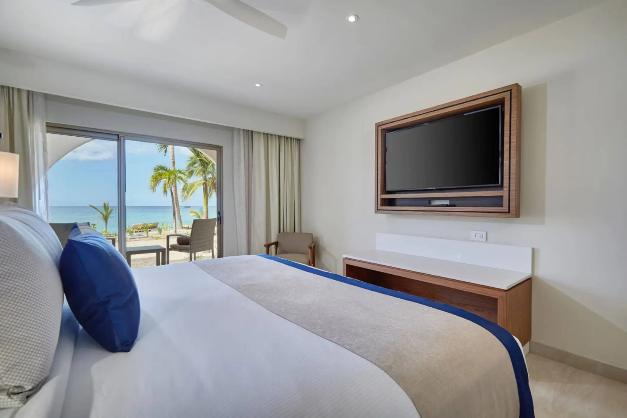 Luxury room with beach walkout views and white bedding at Royalton Grenada, St. George’s