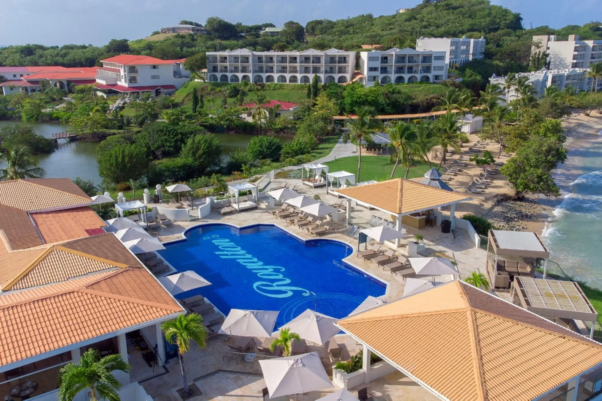 Aerial view of swimming pools and beachfront buildings at Royalton Grenada, St. George’s