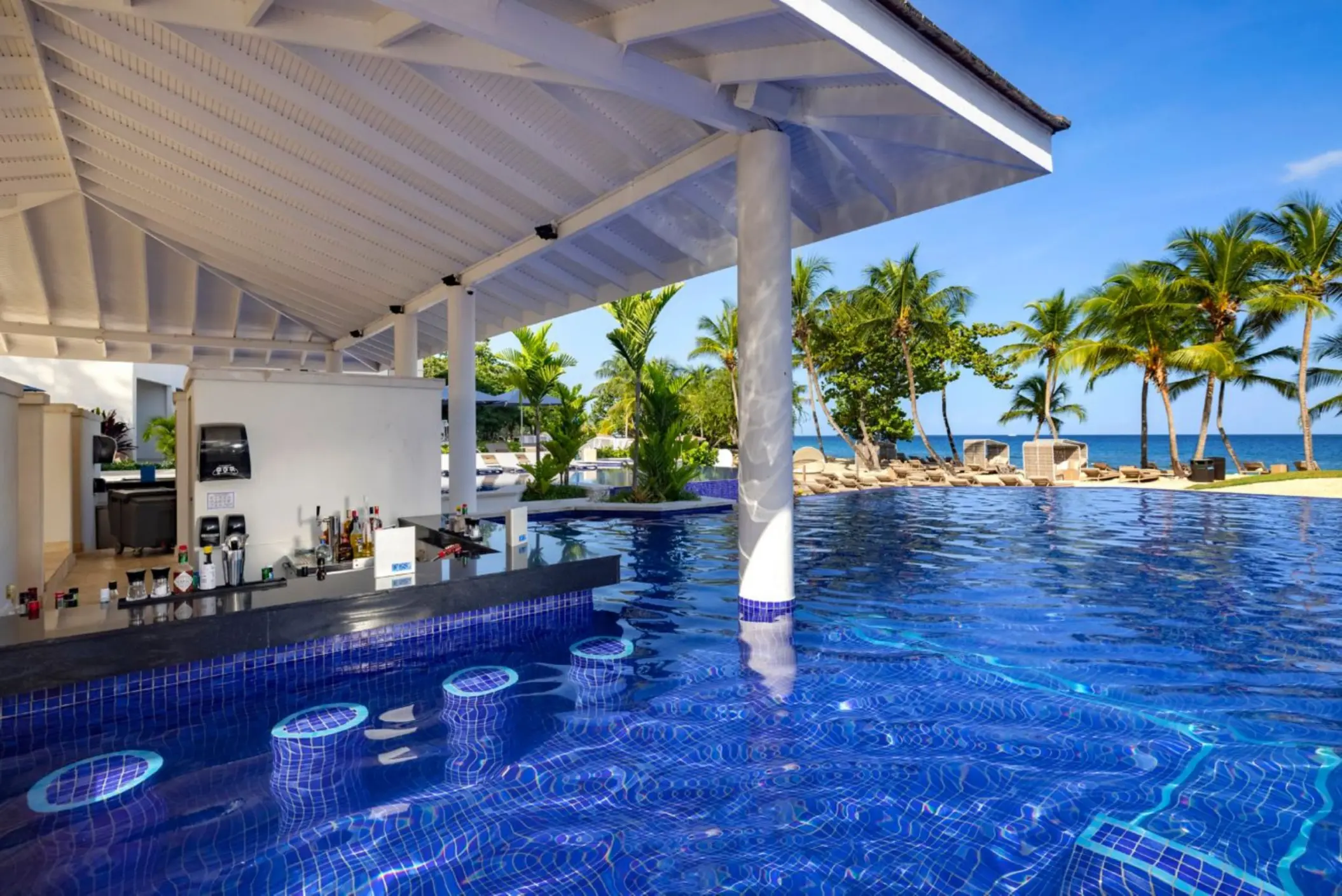 Swim-up bar with blue tiled stools in the pool at Royalton Grenada, St. George’s