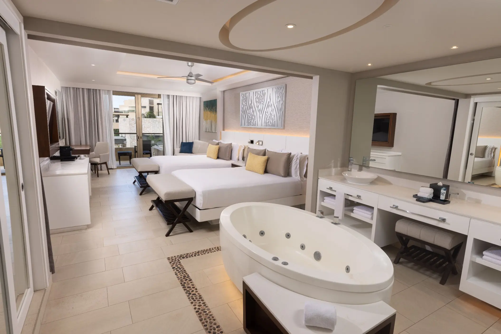 Luxury suite with an in-room jetted tub and two queen beds at Royalton Hideaway Riviera Cancun