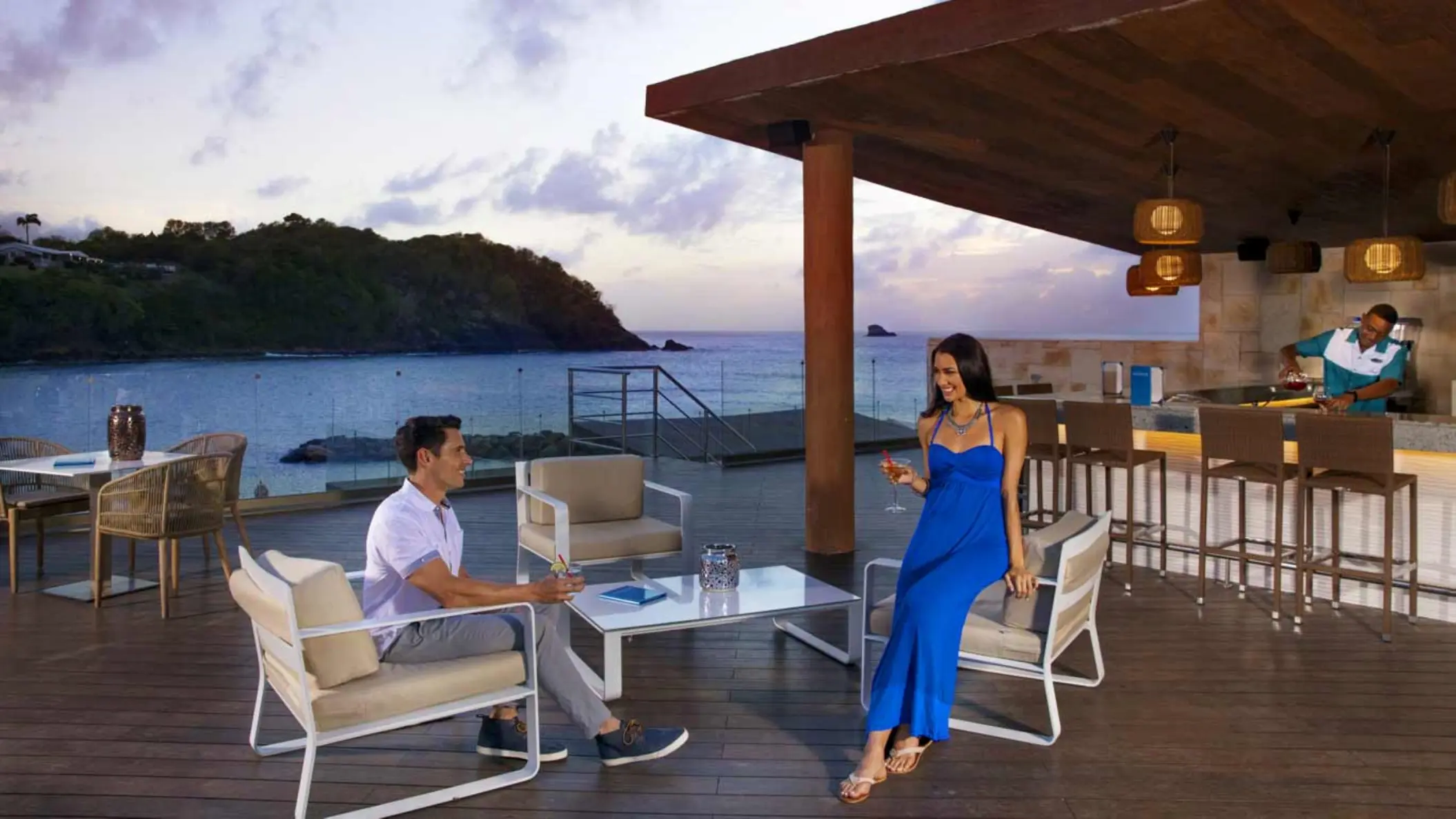Couple enjoying drinks at Aquarius Bar overlooking the ocean at Royalton Hideaway Saint Lucia, Castries