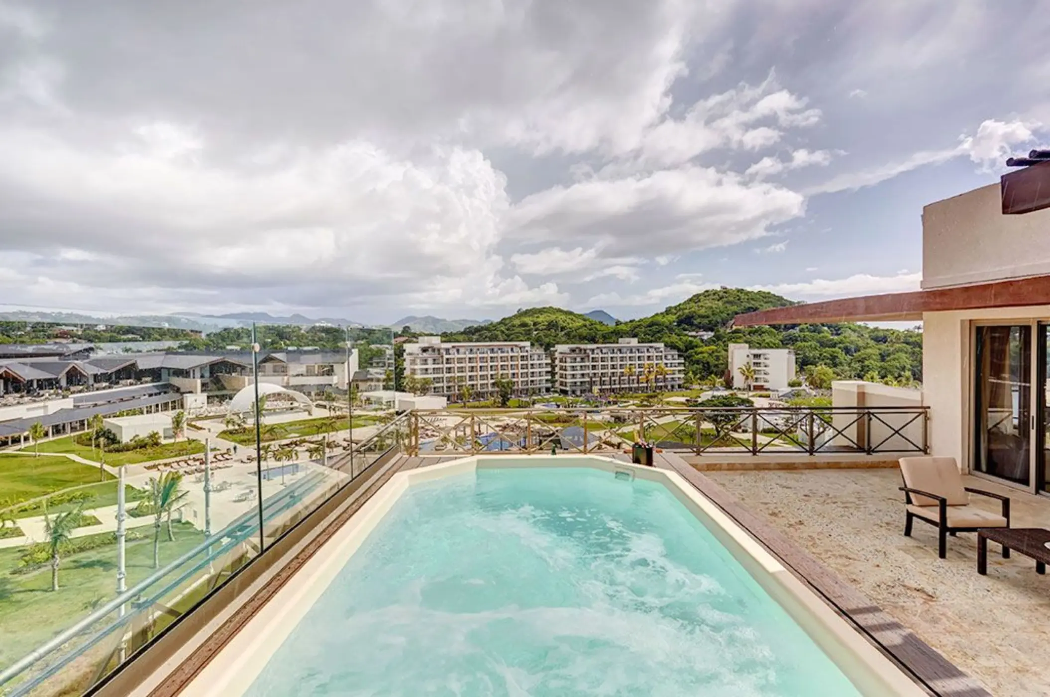 Private terrace hot tub overlooking the resort and hills at Royalton Hideaway, Castries