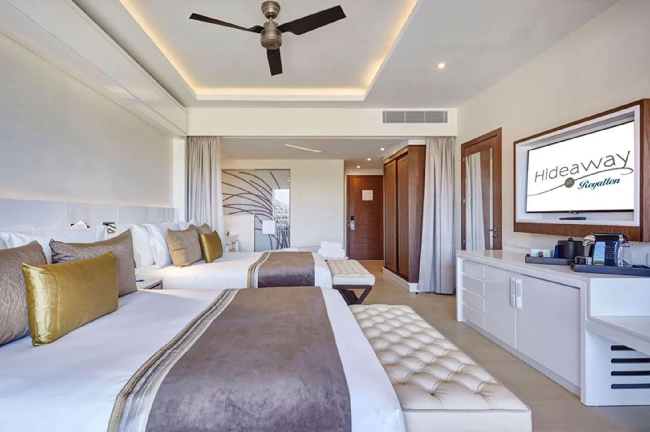 Modern suite with two beds and gold accents at Royalton Hideaway Saint Lucia, Castries