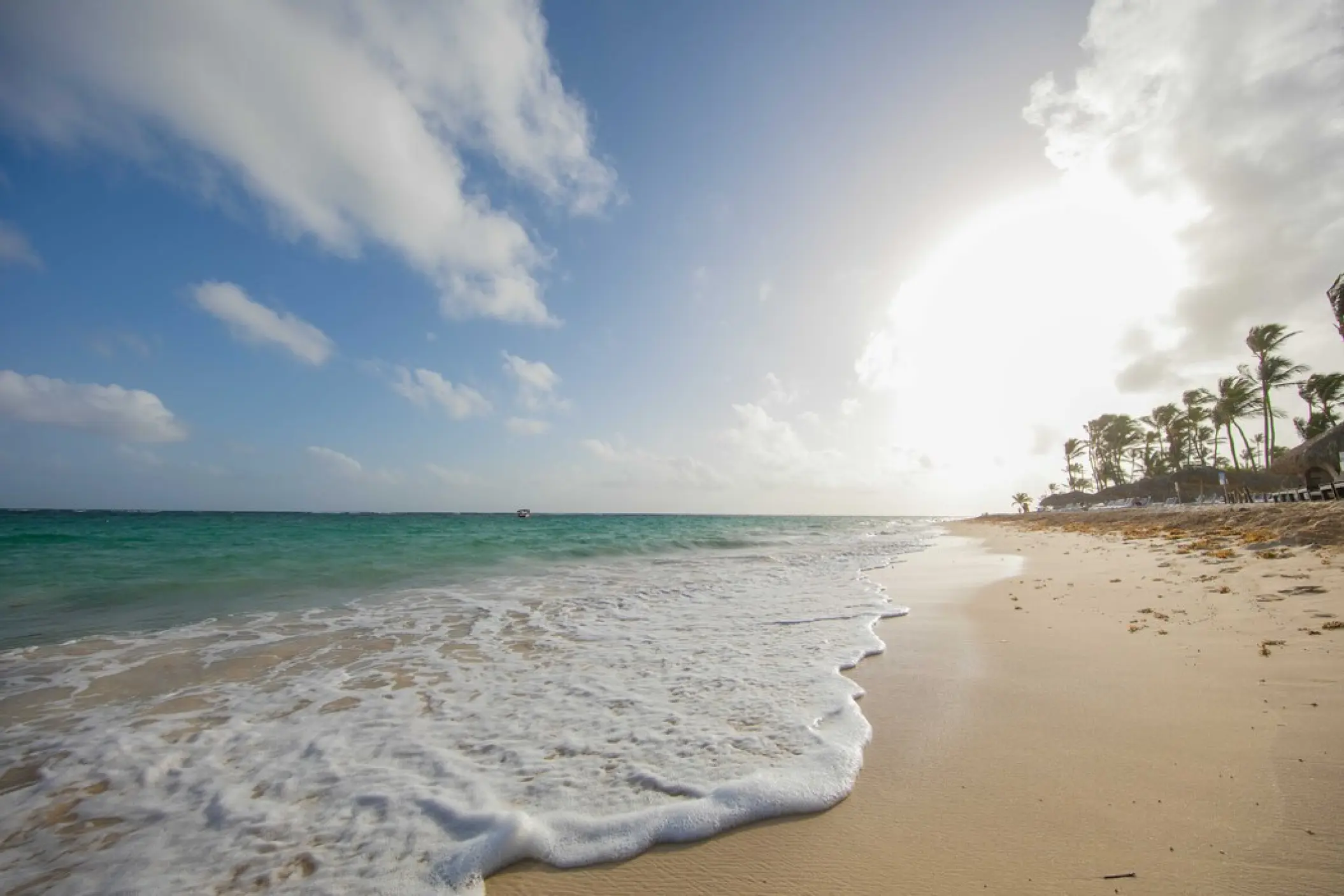 White foam waves washing ashore on the beach at Royalton Punta Cana, Punta Cana