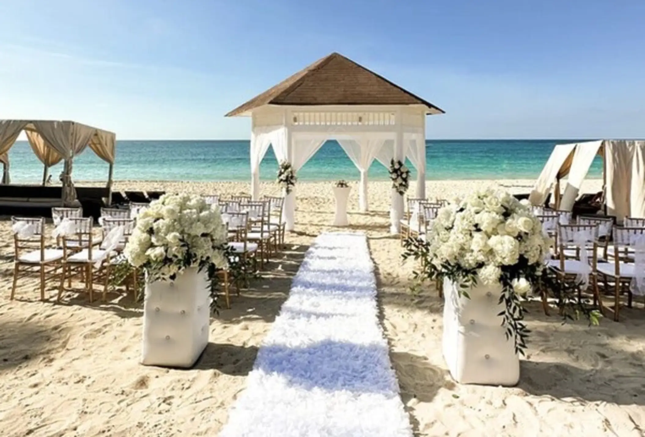Beachfront wedding ceremony setup with a gazebo at Royalton Punta Cana, Punta Cana