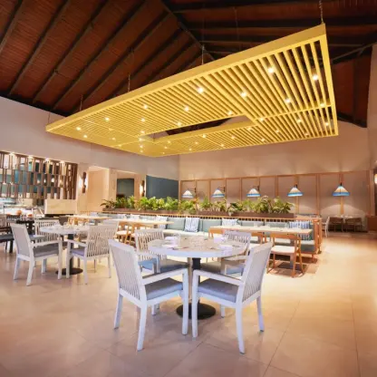 Gourmet Marche restaurant with a modern yellow ceiling installation at Royalton Punta Cana, Punta Cana