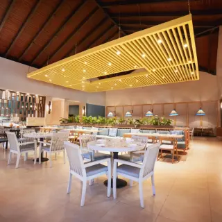Gourmet Marche restaurant with a modern yellow ceiling installation at Royalton Punta Cana, Punta Cana