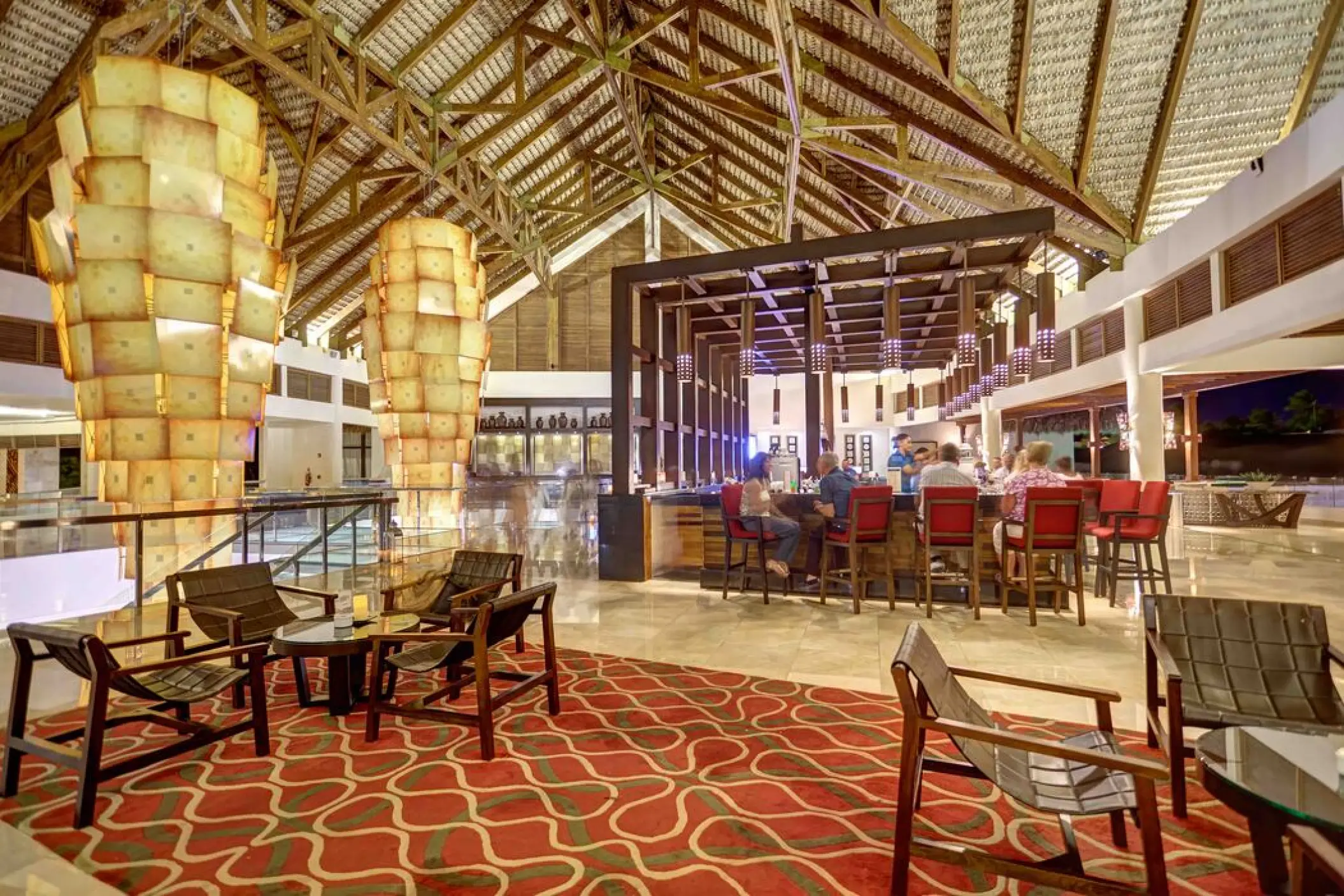 Lobby bar with large hanging lanterns and high vaulted ceilings at Royalton Punta Cana, Punta Cana