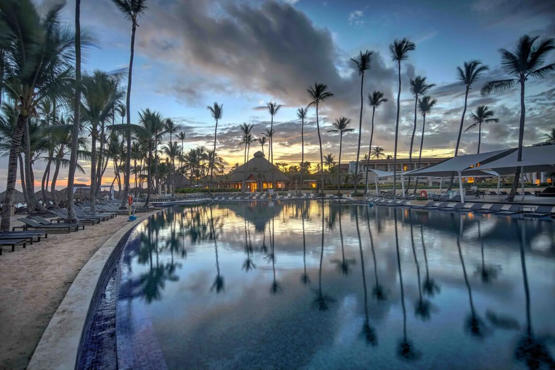 Main pool at Royalton Punta Cana with reflecting palm trees at sunset, Punta Cana