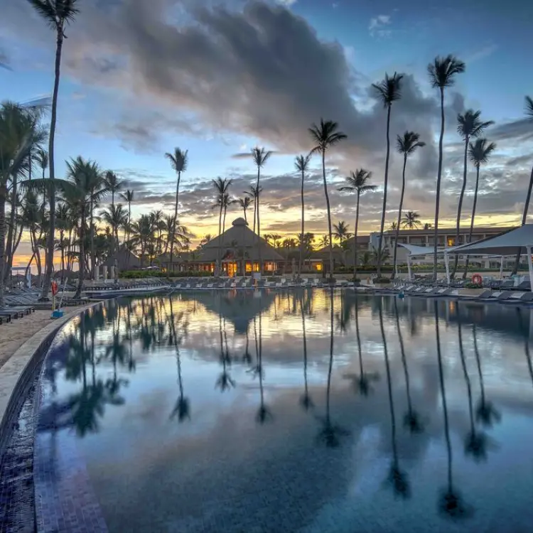Main pool at Royalton Punta Cana with reflecting palm trees at sunset, Punta Cana