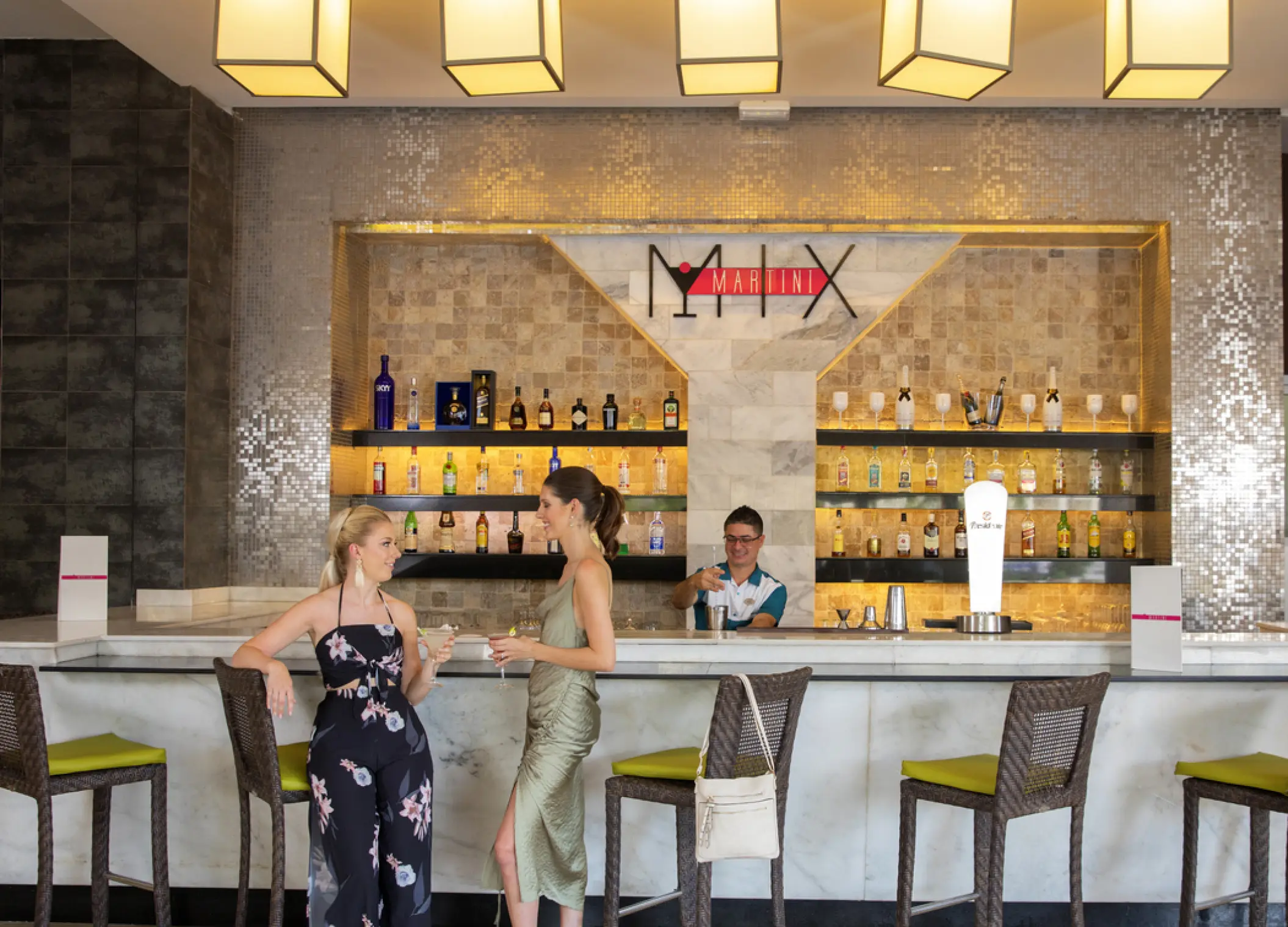 Two women talking at the Martini Mix bar at Royalton Punta Cana, Punta Cana