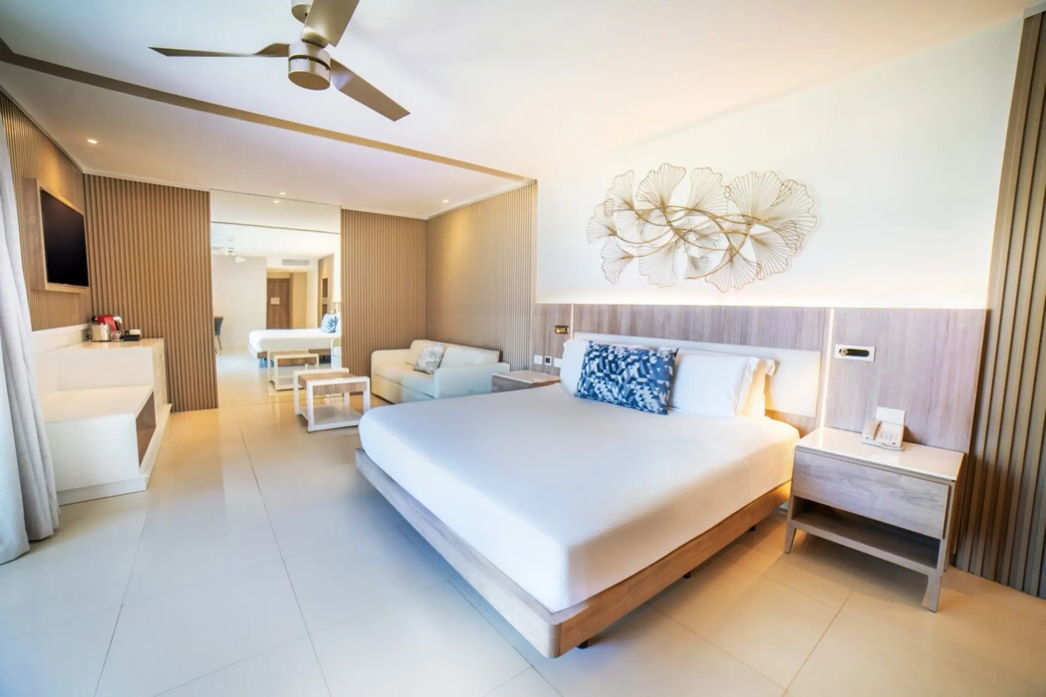 Spacious suite with king bed and modern lounge area at Royalton Punta Cana, Punta Cana
