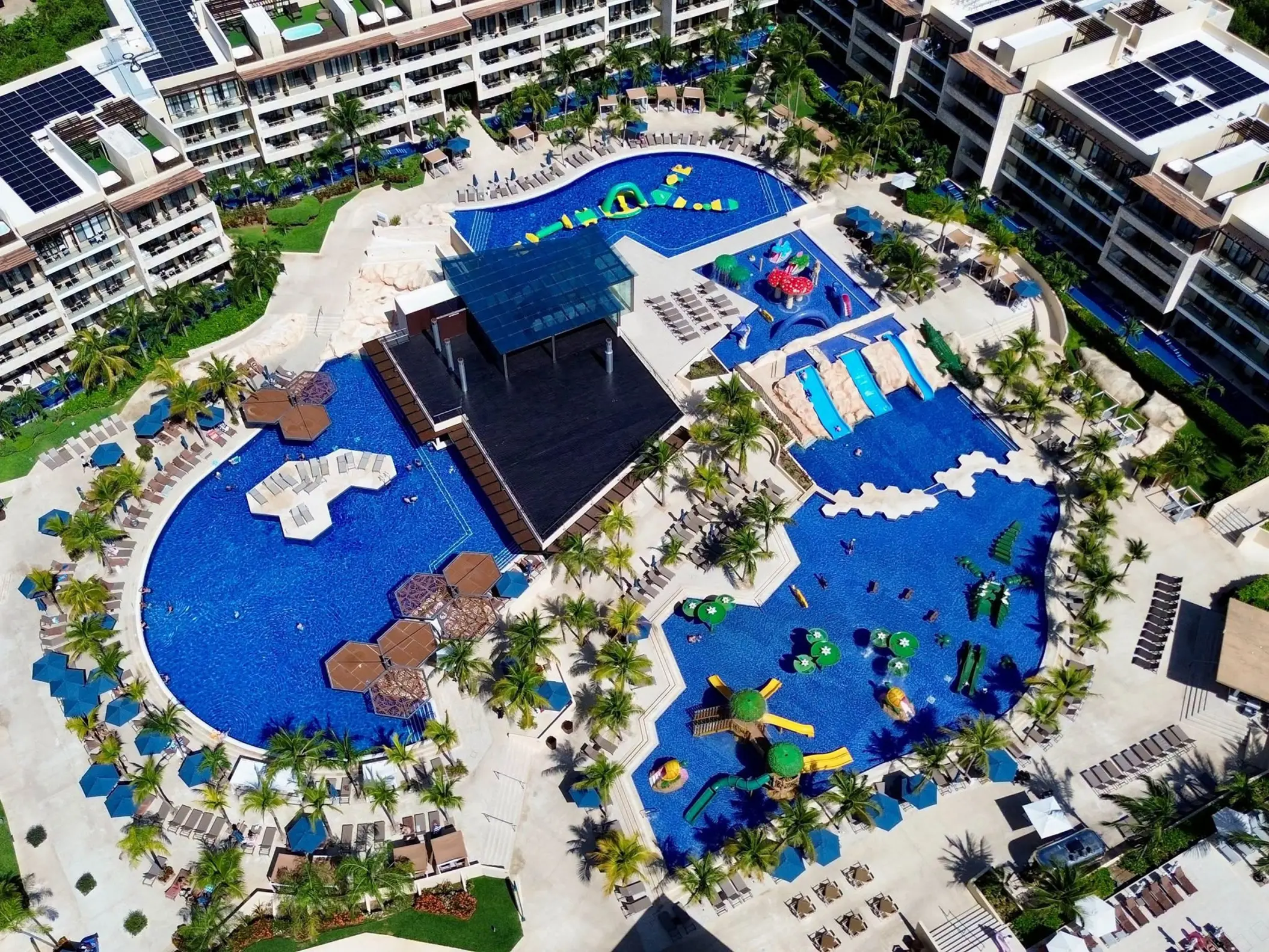 Aerial view of swimming pools and water slides at Royalton Riviera Cancun, Cancun