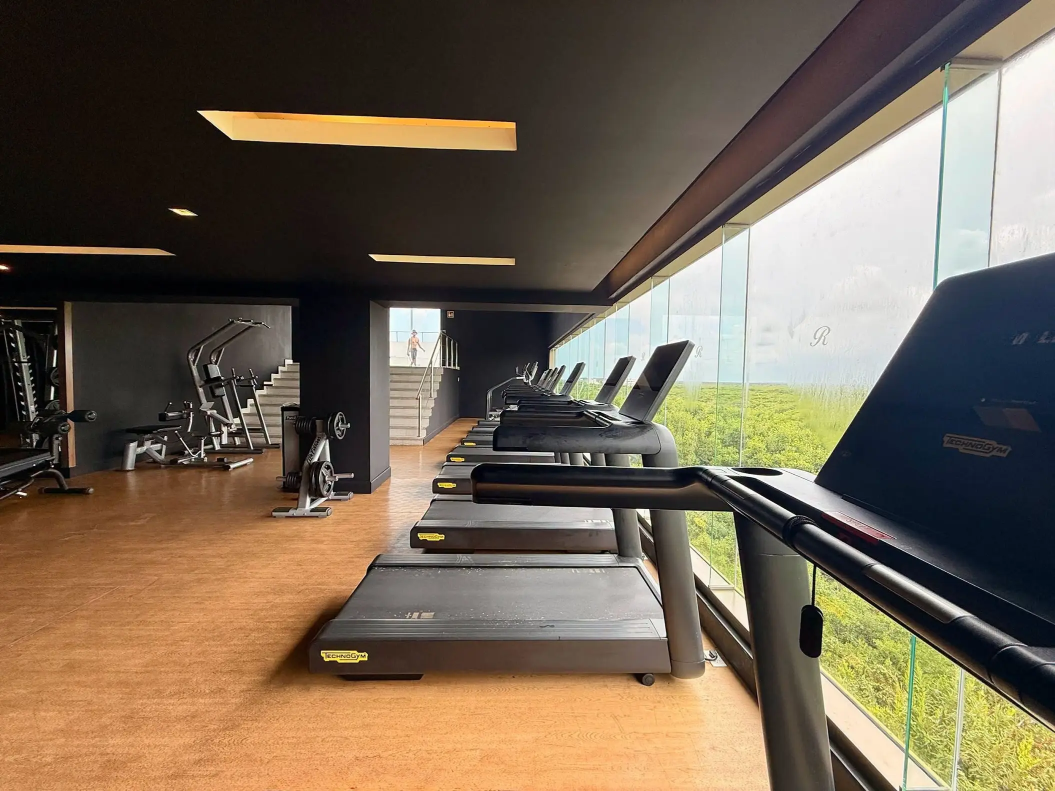 Treadmills in the fitness center at Royalton Riviera Cancun overlooking tropical greenery, Cancun